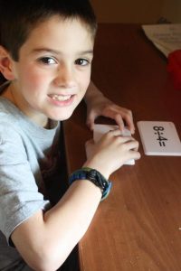 Boy smiling while using robinson curriculum